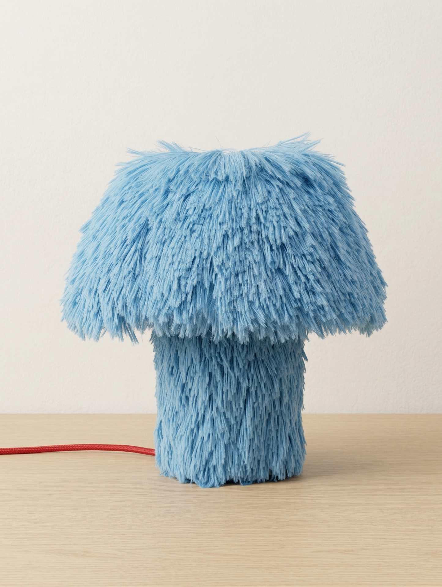 Cookie sculptural table lamp on a light studio background